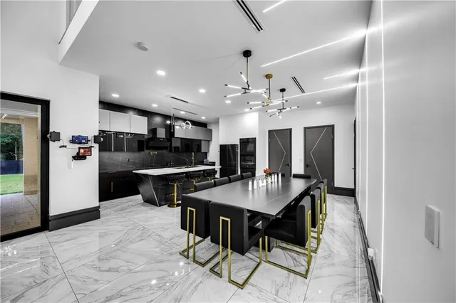 a large kitchen with a table and chairs