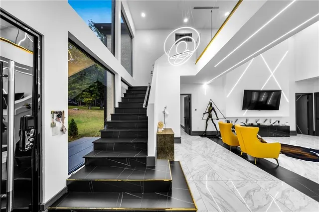 a kitchen with stainless steel appliances kitchen island granite countertop a refrigerator a sink a stove a dining table and chairs