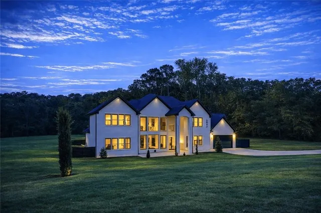 a view of a big yard with a house in the background