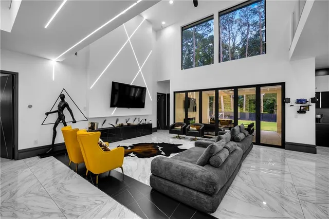 a living room with furniture fireplace and flat screen tv
