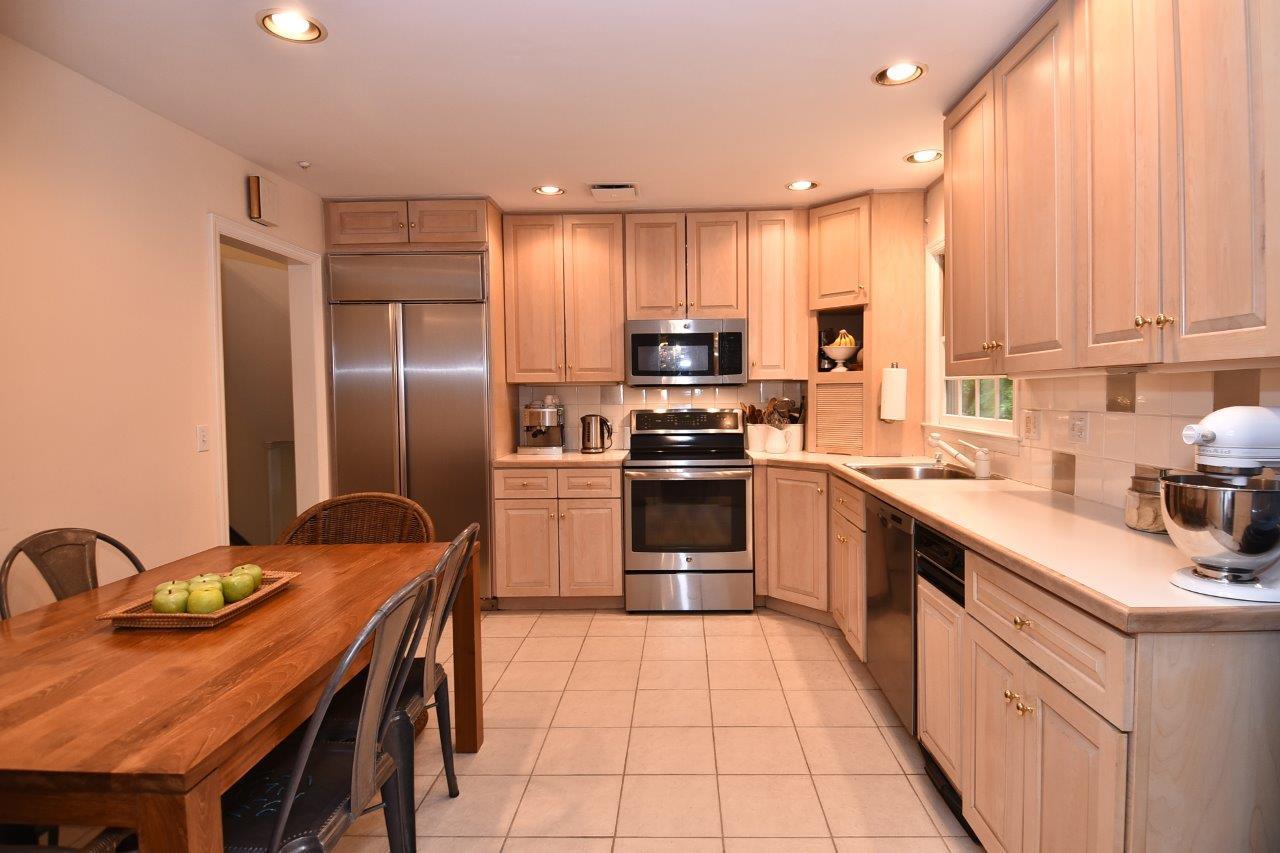 287 Briscoe Road New Canaan, CT 06840 - Photo 14 of 22 a kitchen with stainless steel appliances granite countertop a sink a stove and refrigerator