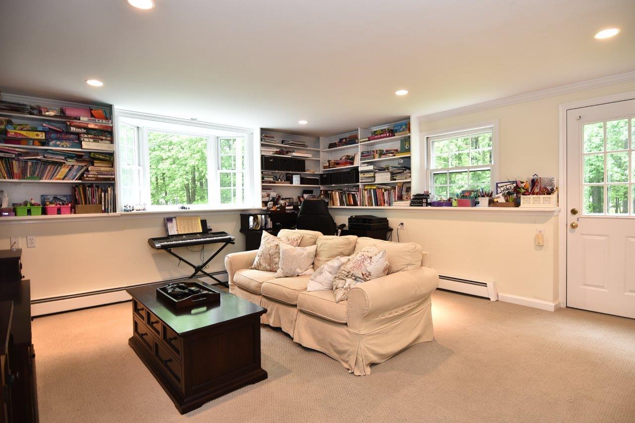 287 Briscoe Road New Canaan, CT 06840 - Photo 15 of 22 a living room with furniture fireplace and a large window