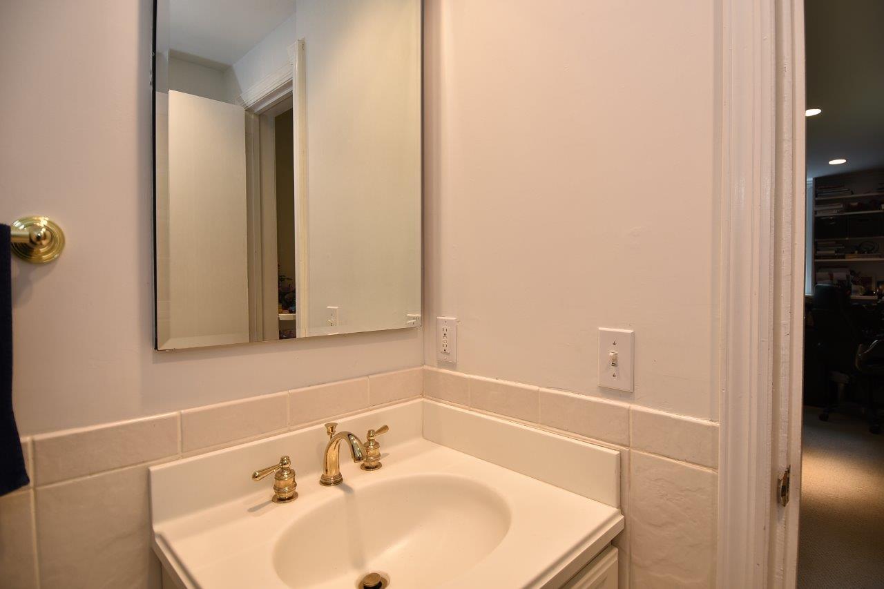287 Briscoe Road New Canaan, CT 06840 - Photo 17 of 22 a bathroom with a sink and a mirror