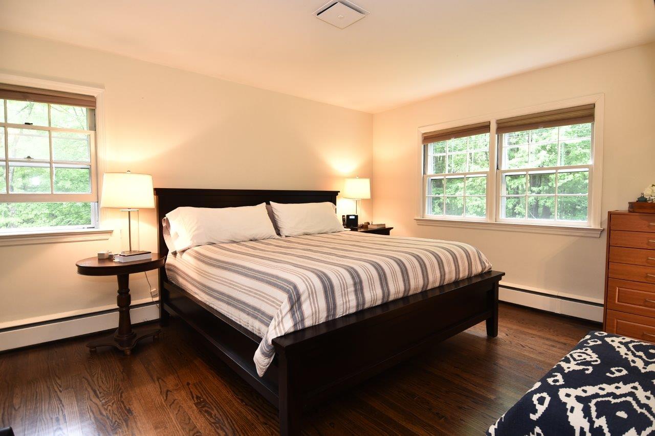 287 Briscoe Road New Canaan, CT 06840 - Photo 21 of 22 a bedroom with a bed and wooden floor