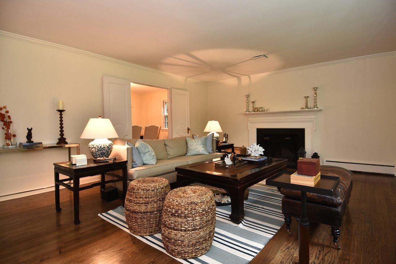 287 Briscoe Road New Canaan, CT 06840 - Photo 4 of 22 a living room with furniture a table and a fireplace