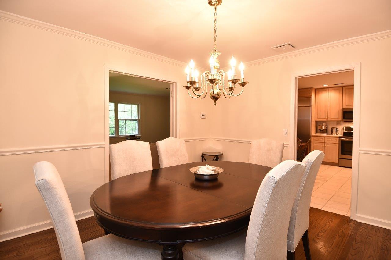 287 Briscoe Road New Canaan, CT 06840 - Photo 7 of 22 a view of a dining room with furniture wooden floor and chandelier