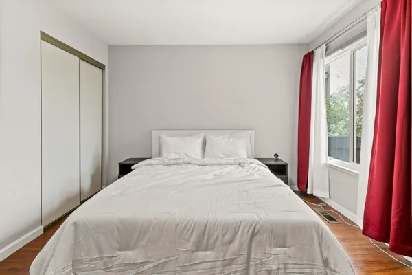 a bedroom with a large bed and a large closet