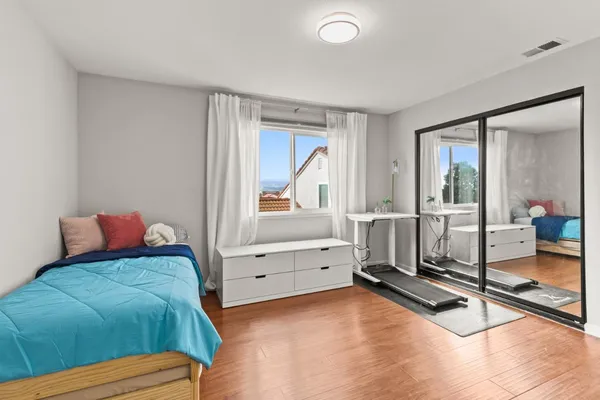 a bedroom with a bed and windows