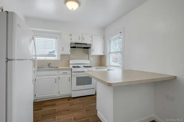 a kitchen with a sink cabinets and window