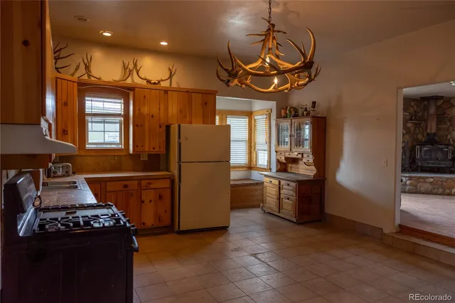 a kitchen with refrigerator a stove and a sink