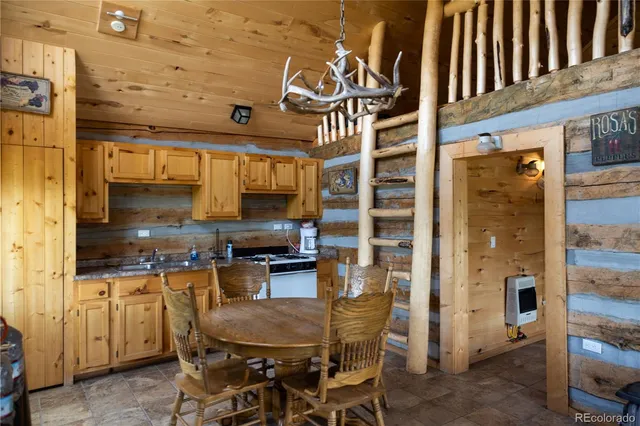 a kitchen with a table chairs refrigerator and cabinets
