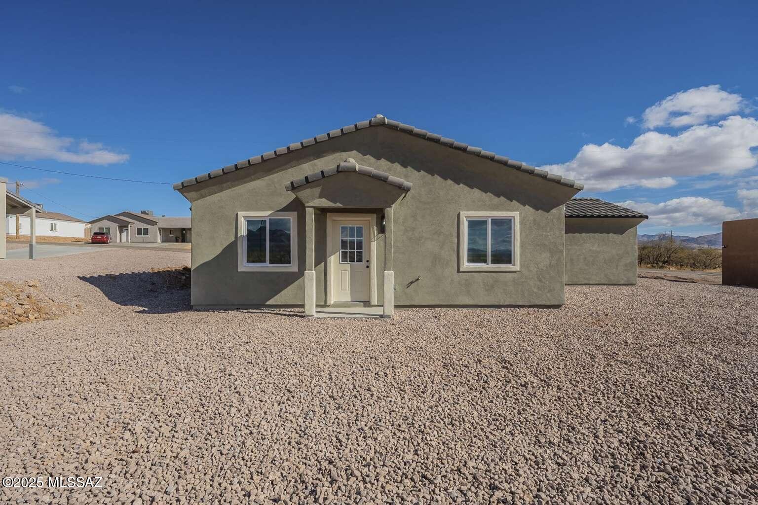 1796 Cajeme Court Rio Rico, AZ 85648 - Photo 34 of 45 a front view of a house with a yard