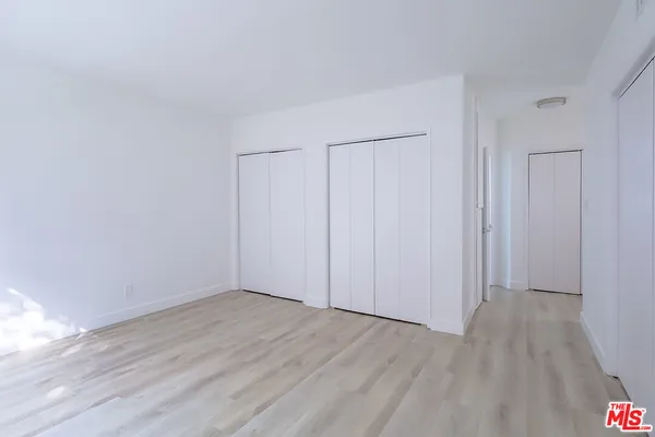 a view of room with wooden floor