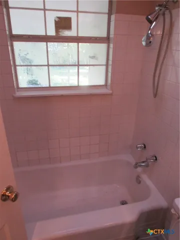 a bath tub sitting next to a window
