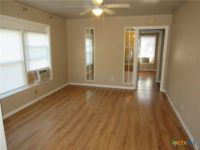 wooden floor in an empty room with a window