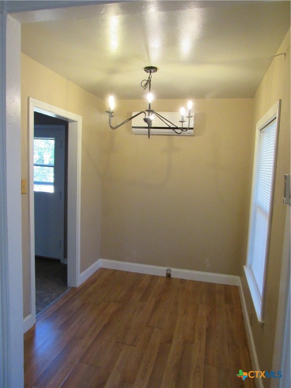 1002 Duncan Avenue Killeen, TX 76541 - Photo 3 of 14 wooden floor in an empty room with a mirror