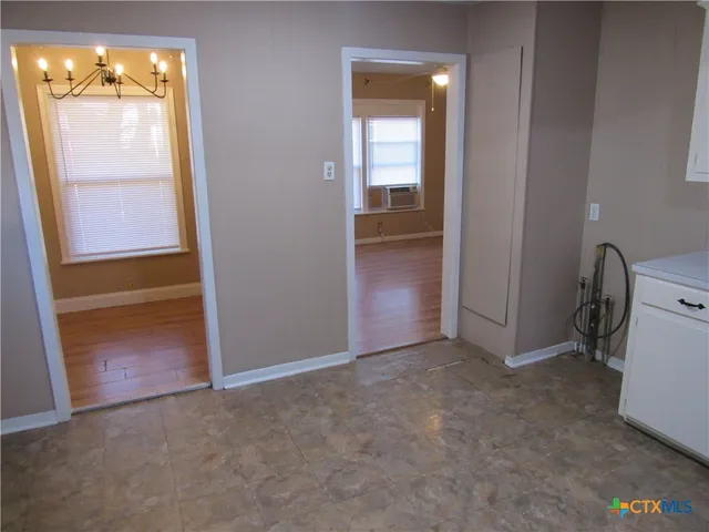 an empty room with windows and closet