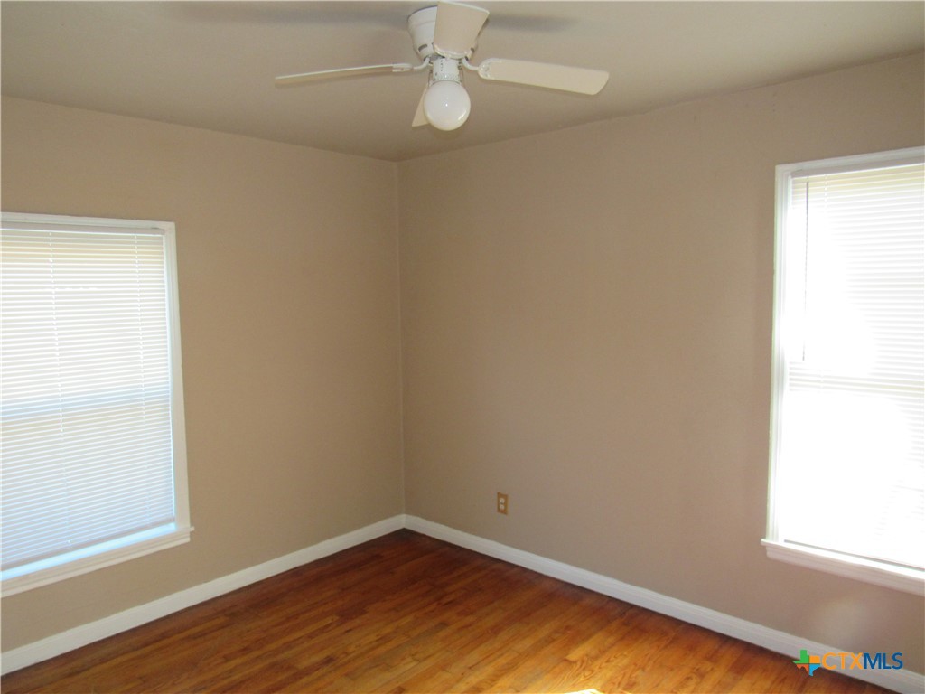 1002 Duncan Avenue Killeen, TX 76541 - Photo 7 of 14 an empty room with wooden floor and windows