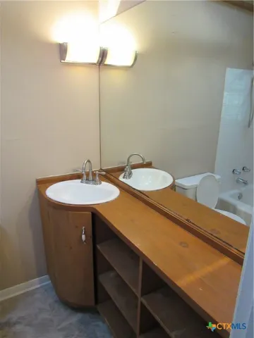 a bathroom with a sink and a mirror