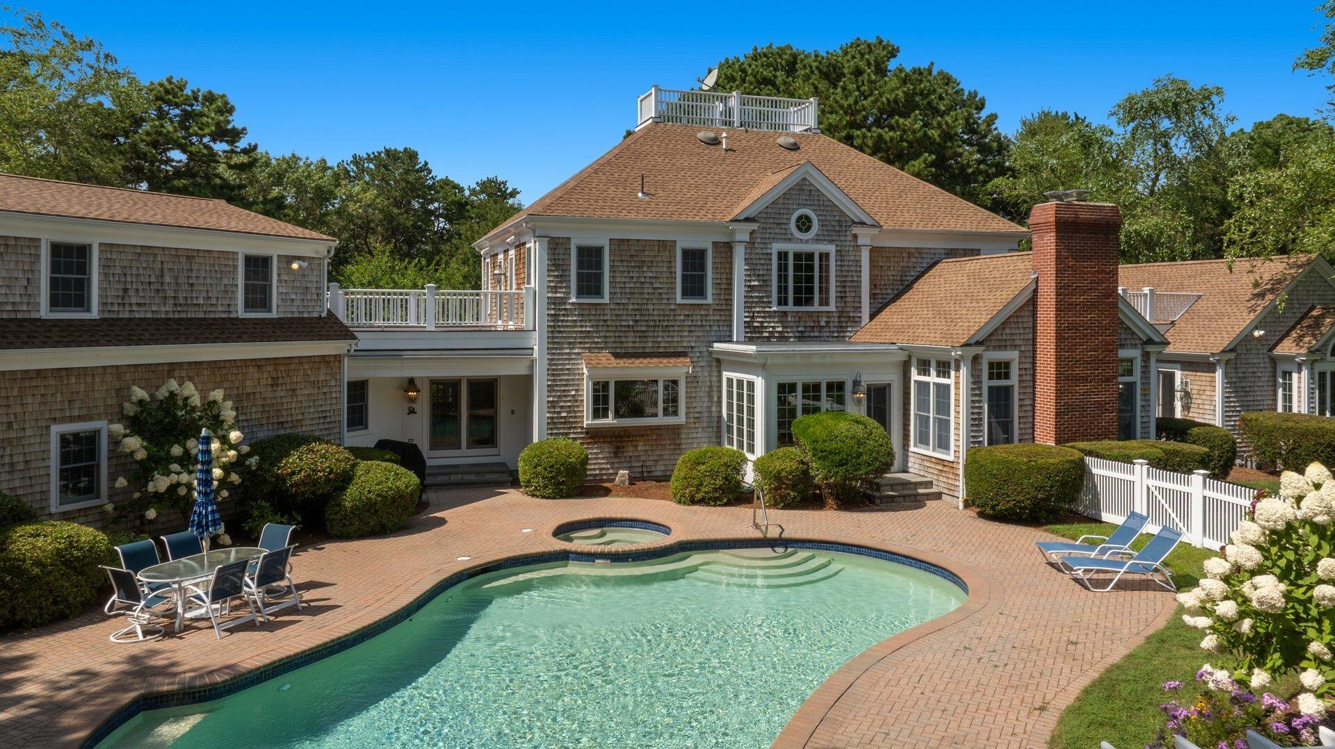 a front view of a house with yard patio and green space