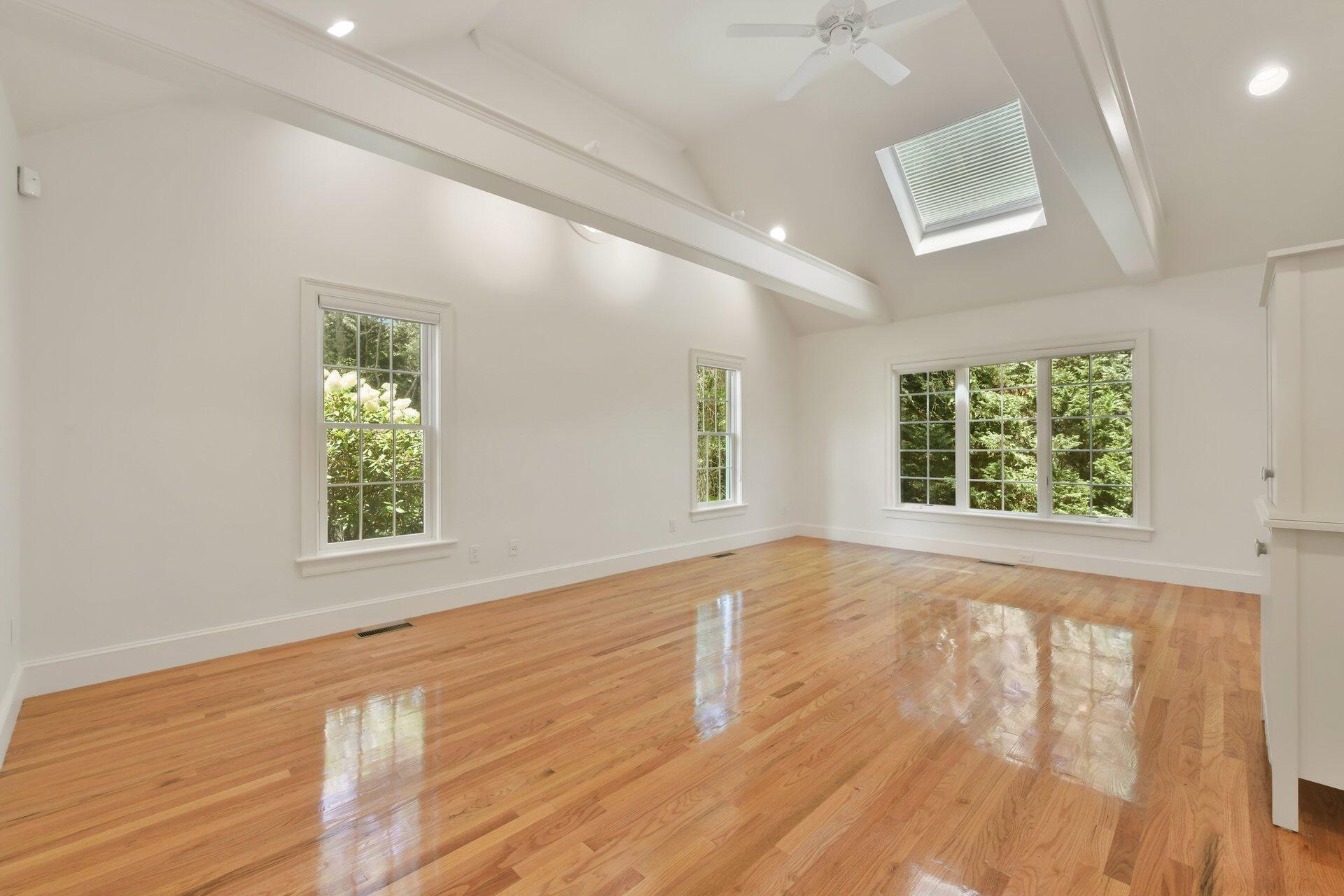 431 Baxter Neck Road Marstons Mills, MA 02648 - Photo 12 of 30 an empty room with wooden floor and windows