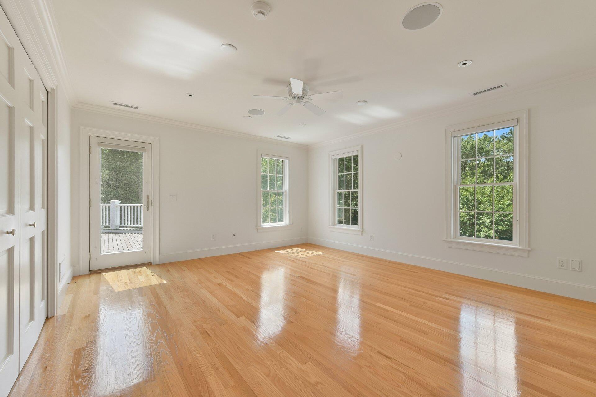 431 Baxter Neck Road Marstons Mills, MA 02648 - Photo 16 of 30 an empty room with wooden floor and windows