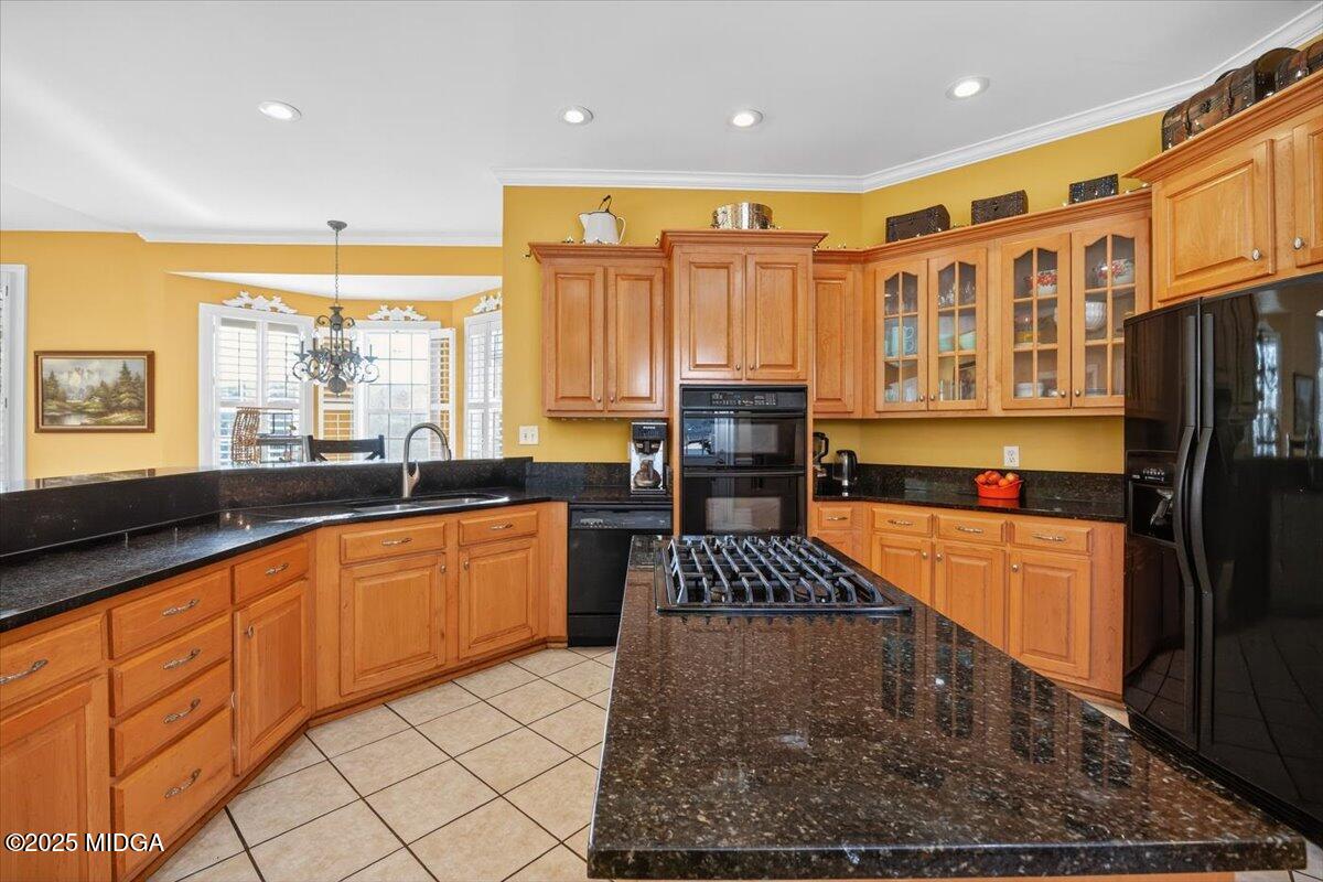 176 Tumbling Shoals Drive Gray, GA 31032 - Photo 12 of 52 a kitchen with stainless steel appliances granite countertop a stove a sink and a refrigerator