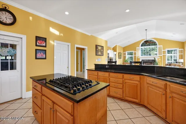 a kitchen with stainless steel appliances a stove a sink and a refrigerator