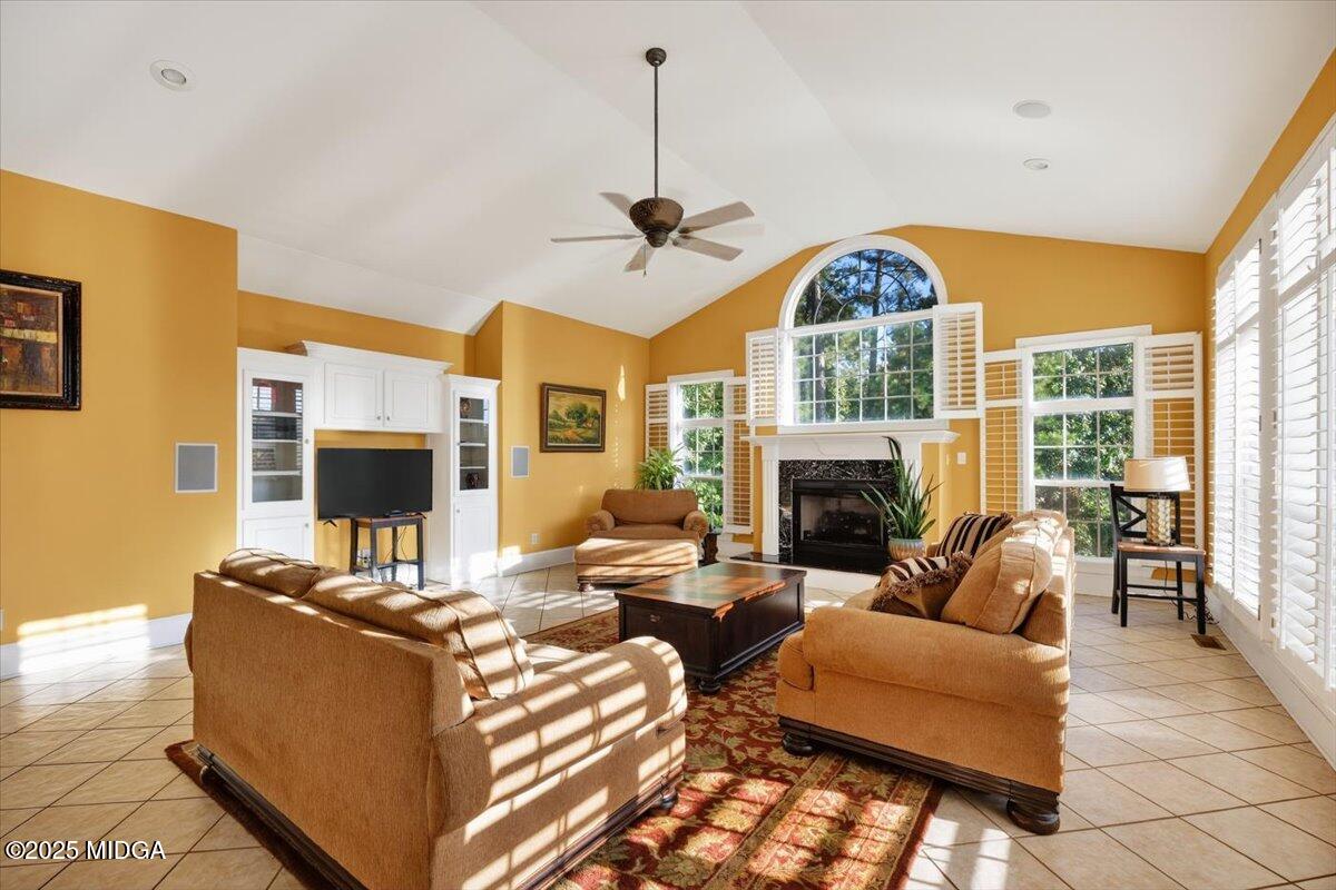176 Tumbling Shoals Drive Gray, GA 31032 - Photo 17 of 52 a living room with fireplace furniture and a large window