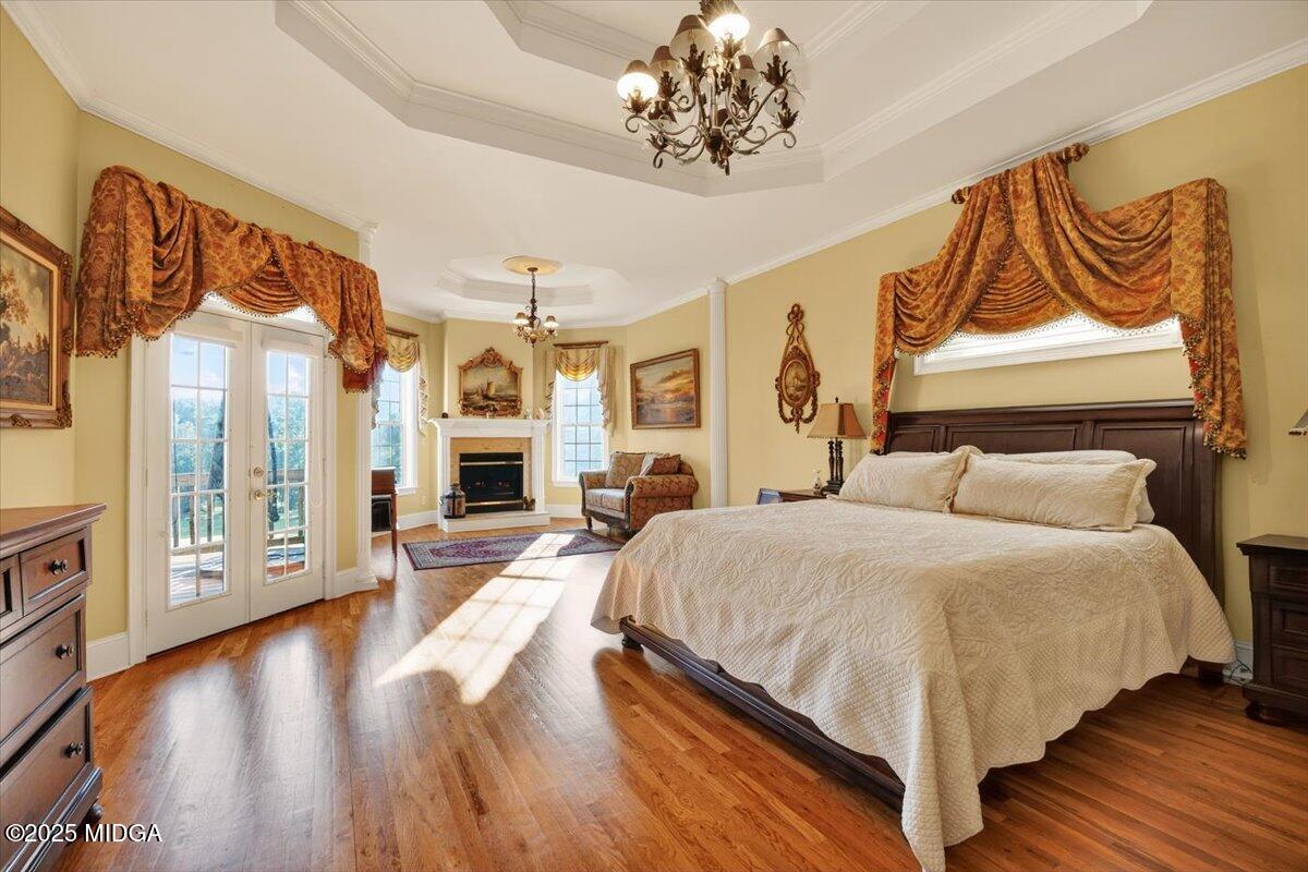 176 Tumbling Shoals Drive Gray, GA 31032 - Photo 18 of 52 a spacious bedroom with a bed and wooden floor