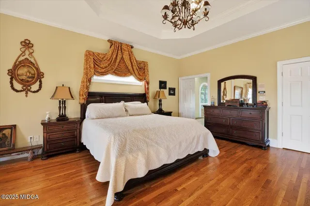 a bedroom with a bed and a chandelier