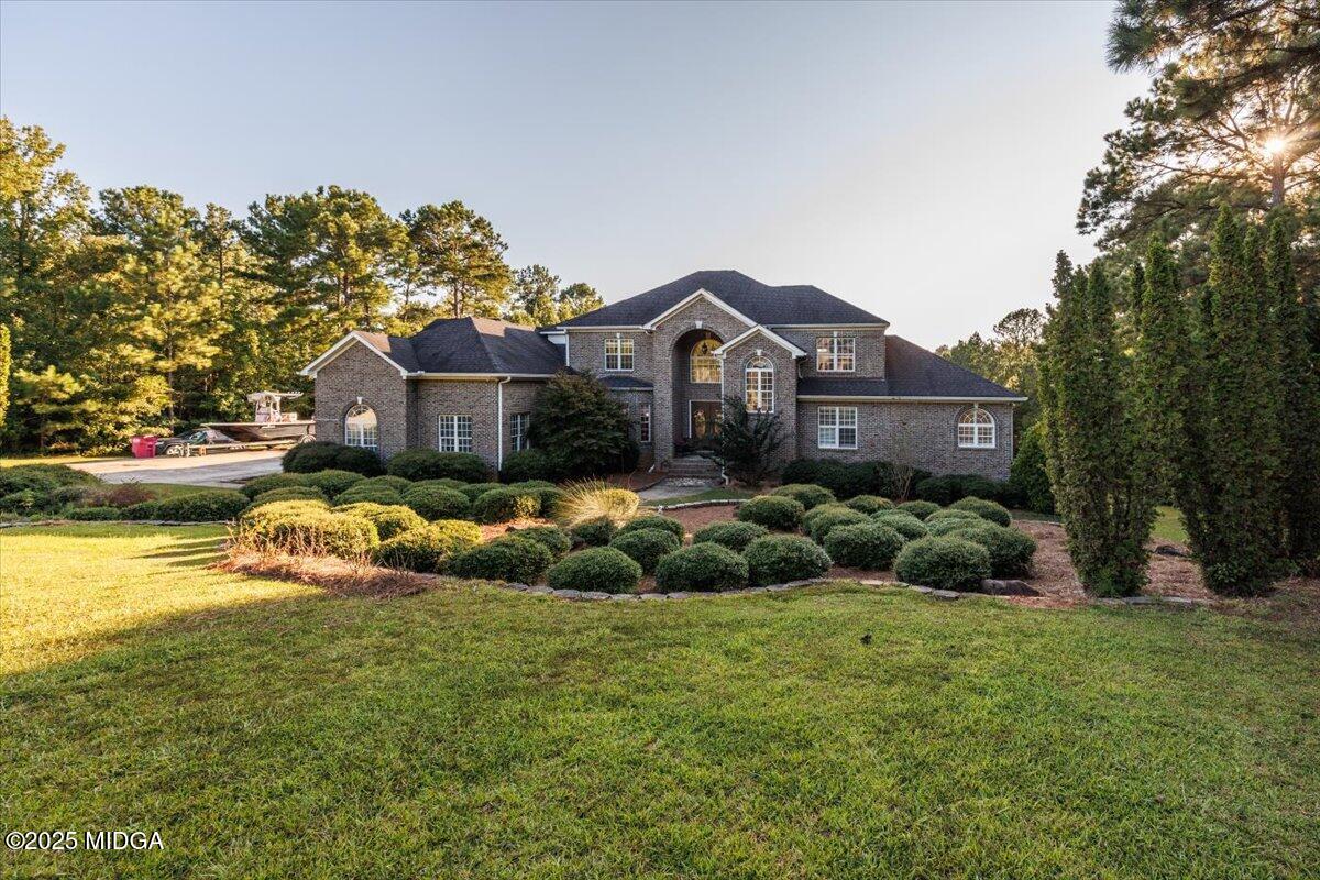 176 Tumbling Shoals Drive Gray, GA 31032 - Photo 2 of 52 a front view of a house with a garden and plants