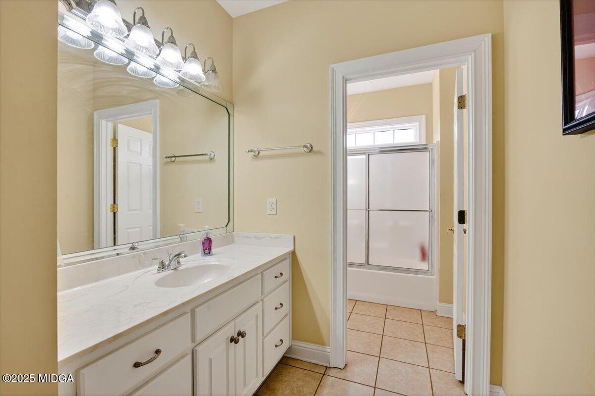 176 Tumbling Shoals Drive Gray, GA 31032 - Photo 29 of 52 a bathroom with a double vanity sink and a mirror