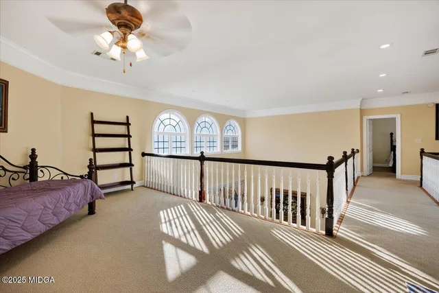 a bed sitting in a bedroom next to a window
