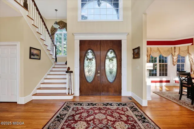 an entryway with bench and wooden floor