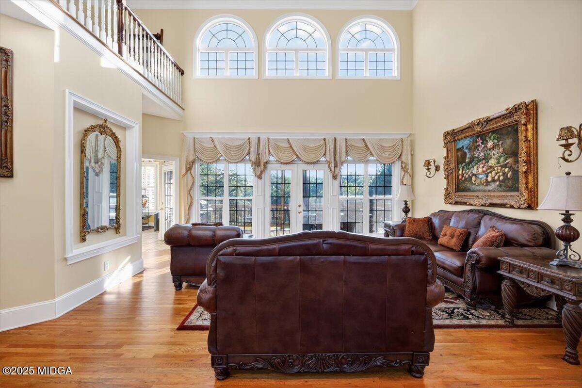 176 Tumbling Shoals Drive Gray, GA 31032 - Photo 8 of 52 a living room with furniture and a floor to ceiling window