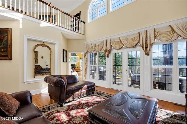 a living room with furniture fireplace and a large window