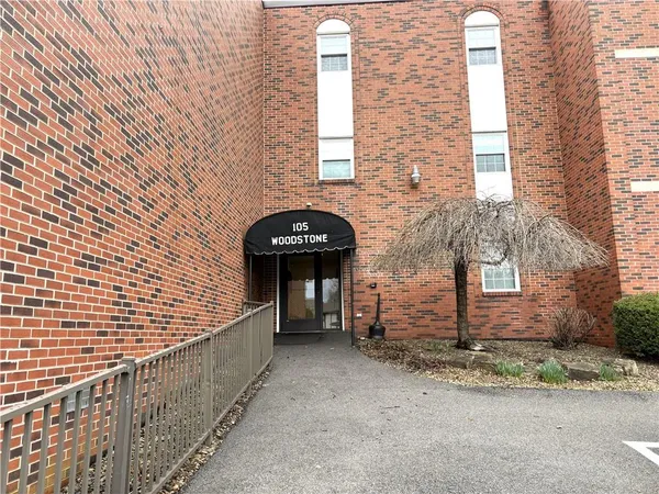 a view of wooden door and brick wall