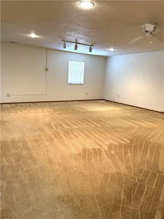 an empty room with window and wooden floor