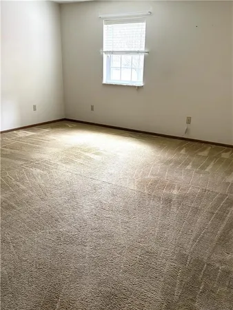 an empty room with closet and wooden floor
