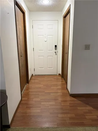 a view of a hallway with wooden floor