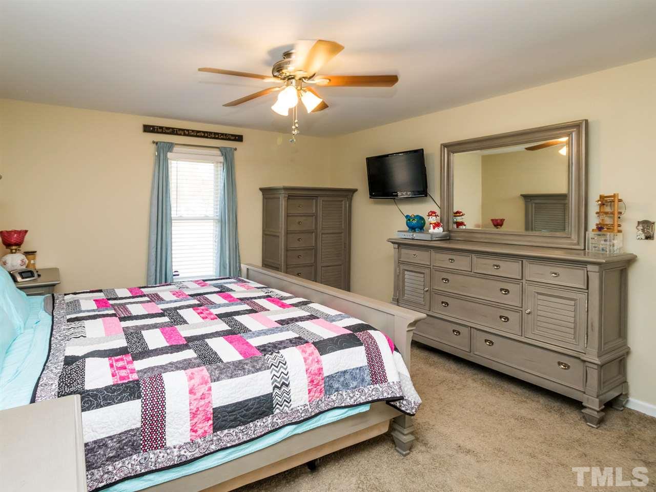 10017 Joe Leach Road Raleigh, NC 27603 - Photo 13 of 23 a bedroom with a bed and a dresser in it