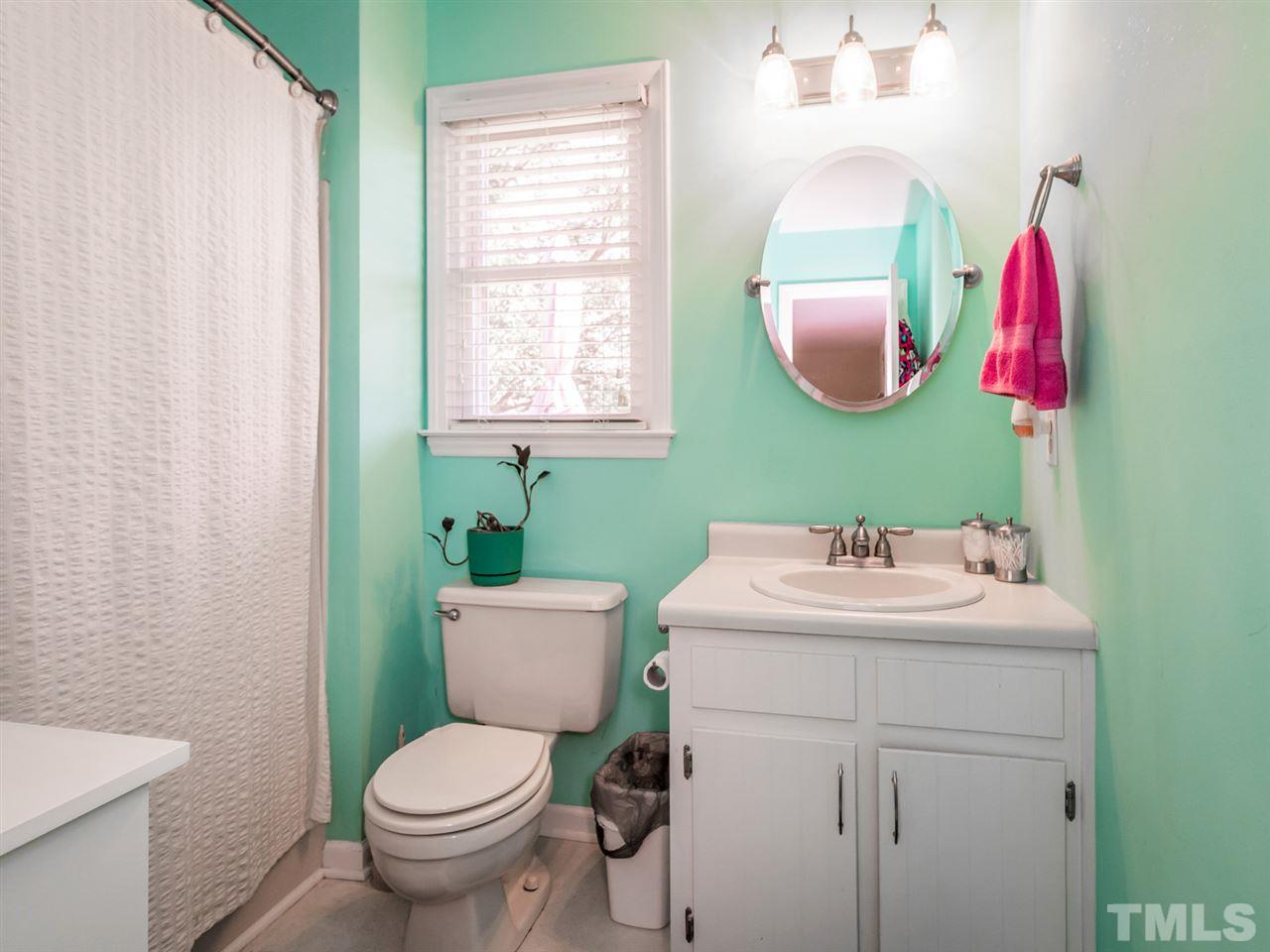 10017 Joe Leach Road Raleigh, NC 27603 - Photo 15 of 23 a bathroom with a sink toilet and mirror