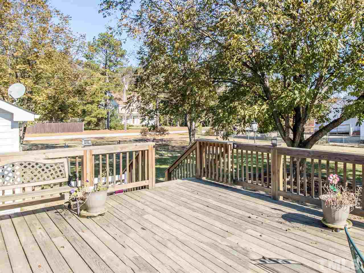 10017 Joe Leach Road Raleigh, NC 27603 - Photo 19 of 23 a view of a wooden deck and a yard