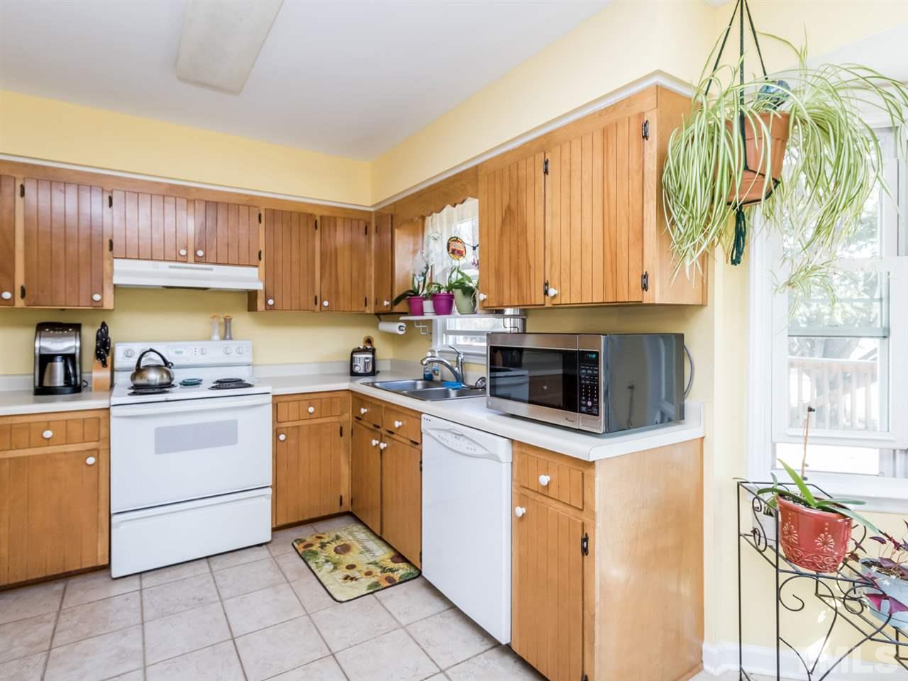 10017 Joe Leach Road Raleigh, NC 27603 - Photo 5 of 23 a kitchen with a sink cabinets and window