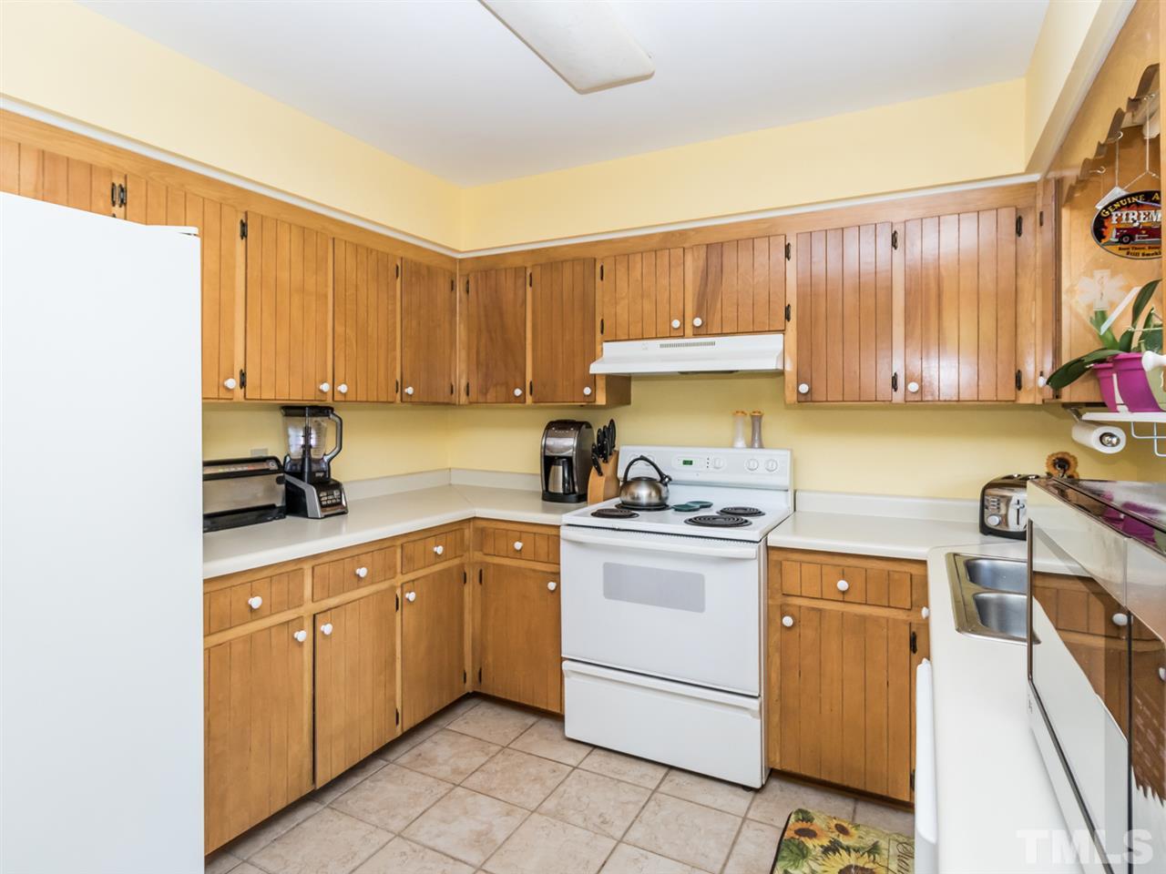 10017 Joe Leach Road Raleigh, NC 27603 - Photo 6 of 23 a kitchen with a sink stove and cabinets
