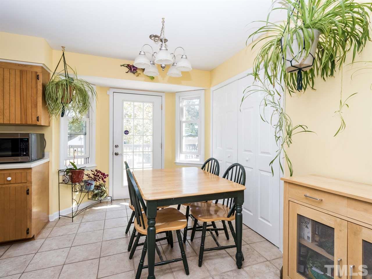10017 Joe Leach Road Raleigh, NC 27603 - Photo 7 of 23 a view of a dining room with furniture a livingroom and chandelier