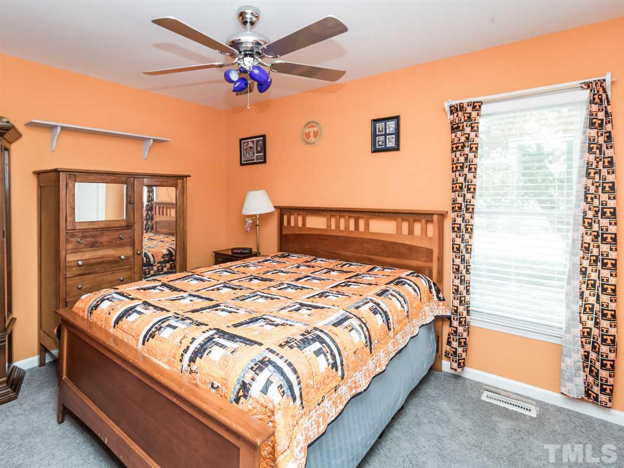 10017 Joe Leach Road Raleigh, NC 27603 - Photo 10 of 23 a large bed sitting in a bedroom next to a window