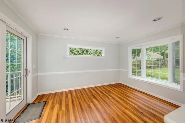a view of a room with wooden floor and windows