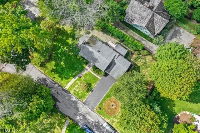 an aerial view of a house with a garden and plants